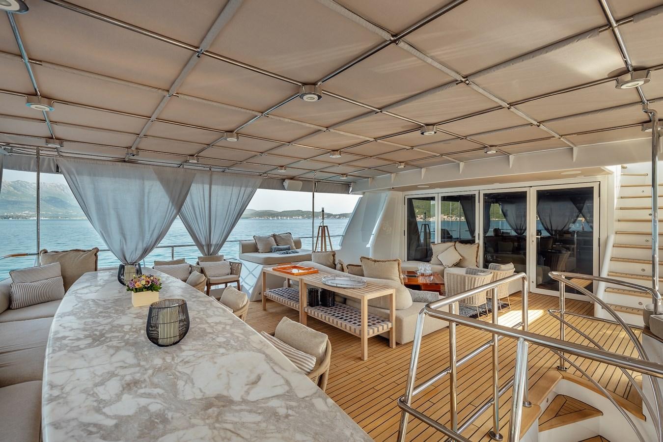 a large living room with a large balcony aboard ZULU Yacht for Sale