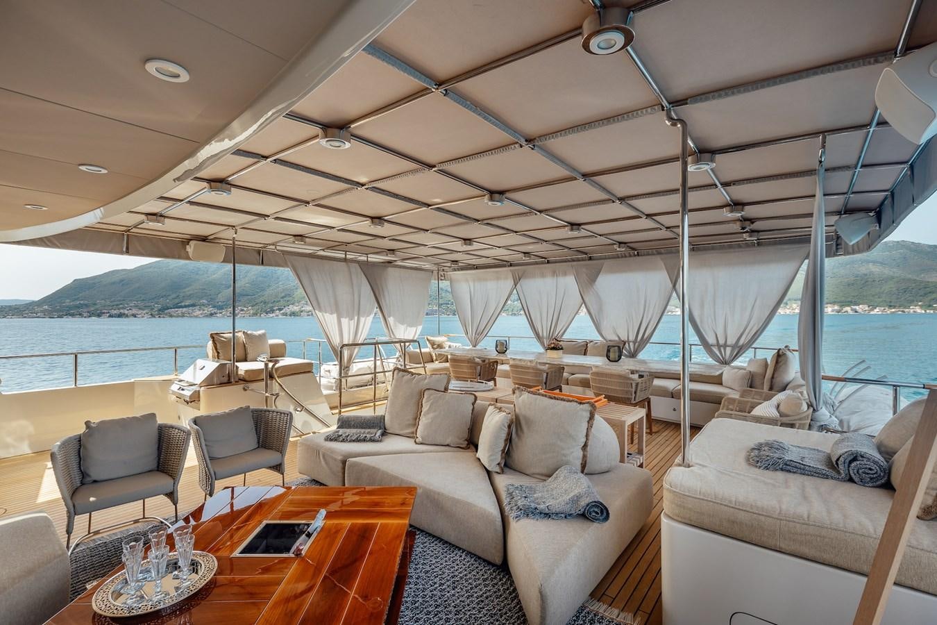 a boat with a couch and a table and chairs aboard ZULU Yacht for Sale