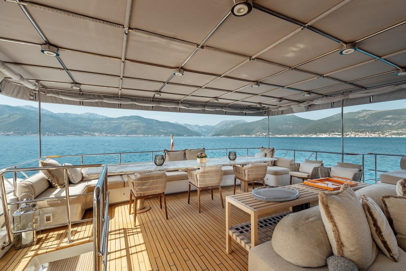 a deck with chairs and tables on it aboard ZULU Yacht for Sale