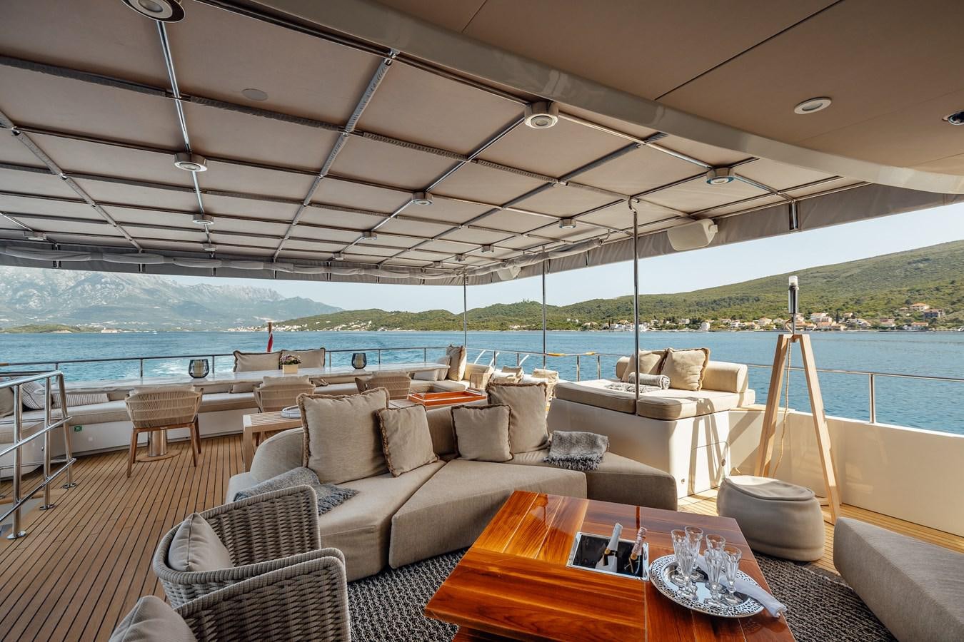 a living room with a large body of water and a large patio aboard ZULU Yacht for Sale