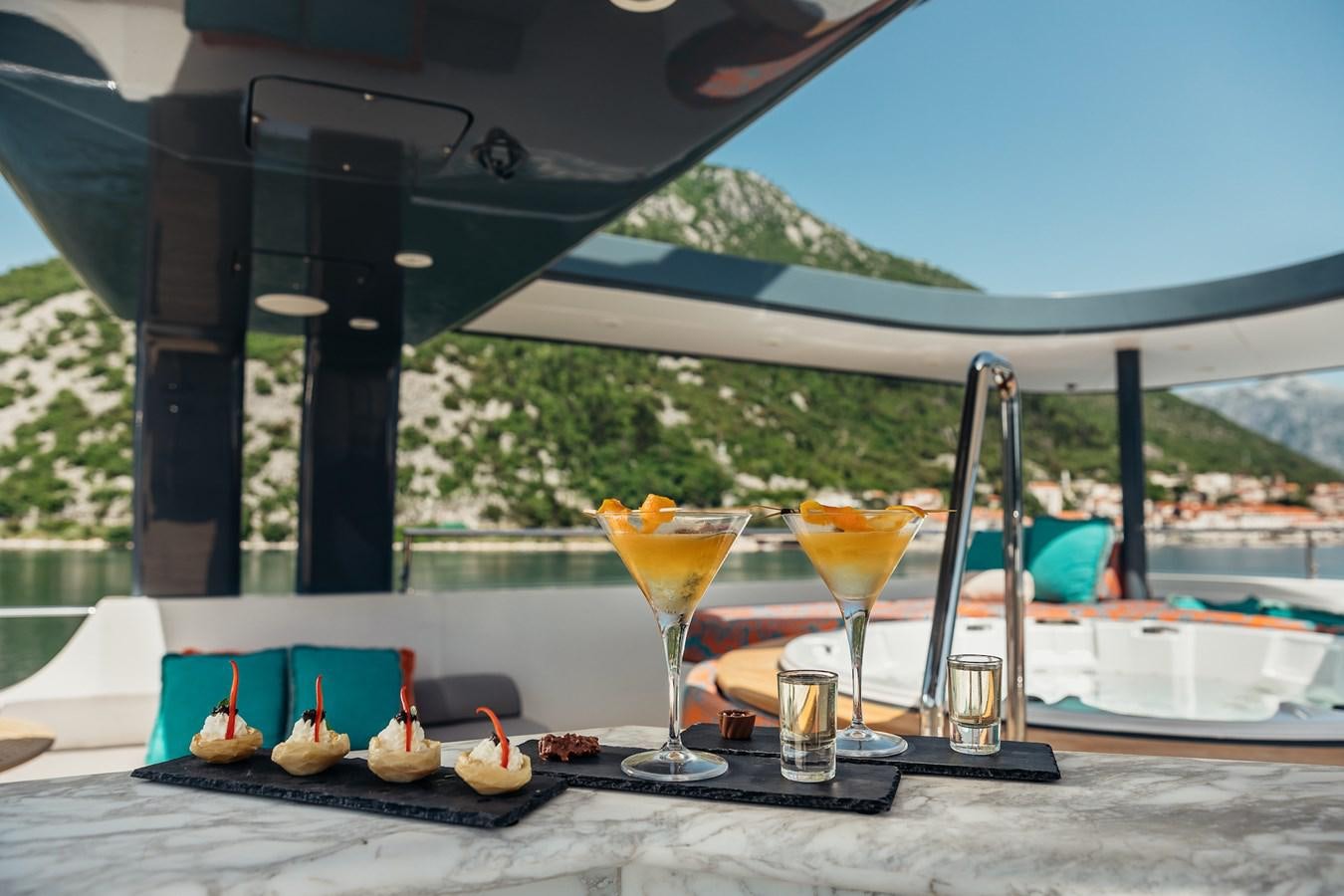 a table with food and drinks on it aboard ZULU Yacht for Sale