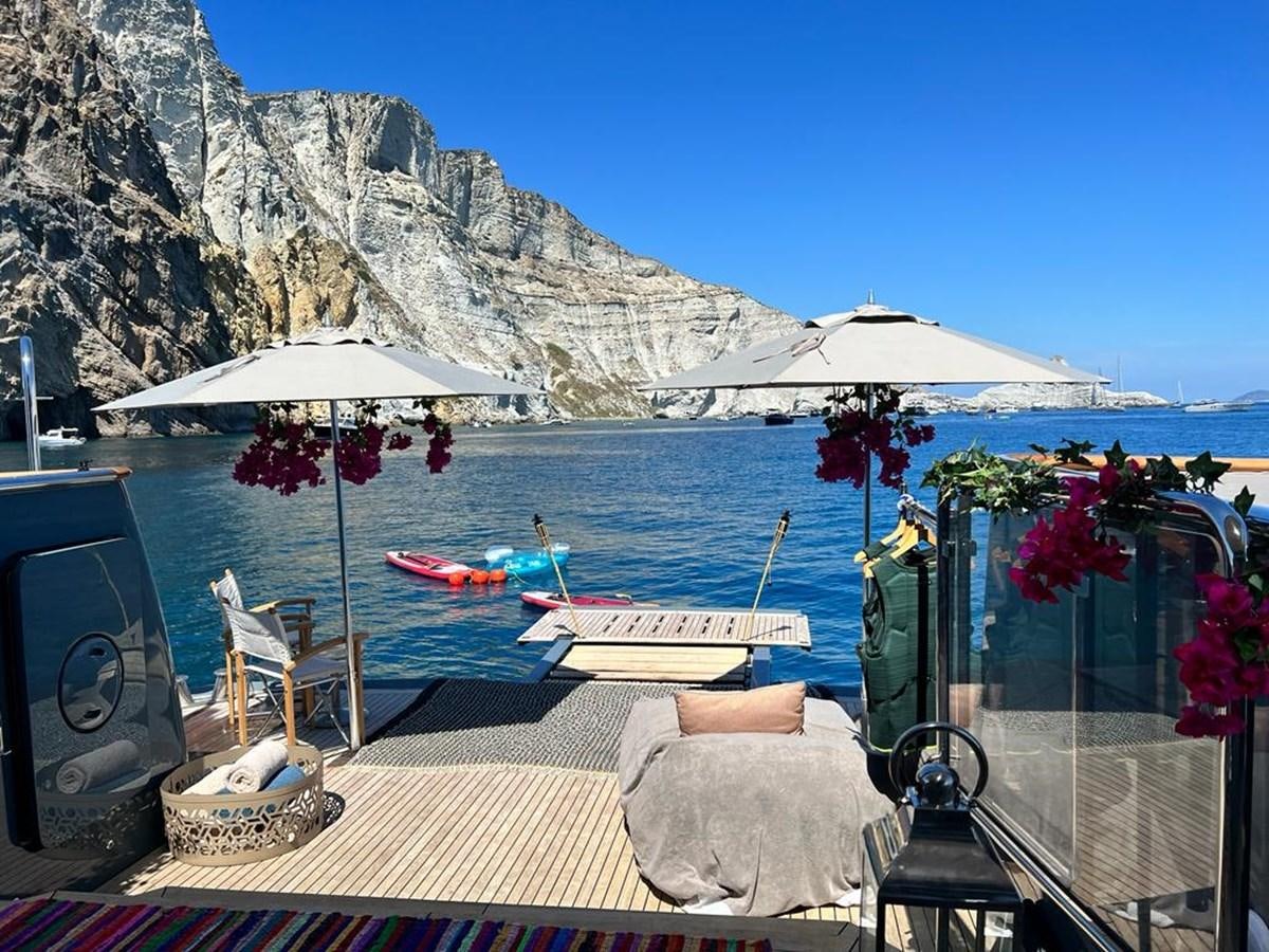 a deck with chairs and umbrellas aboard ZULU Yacht for Sale