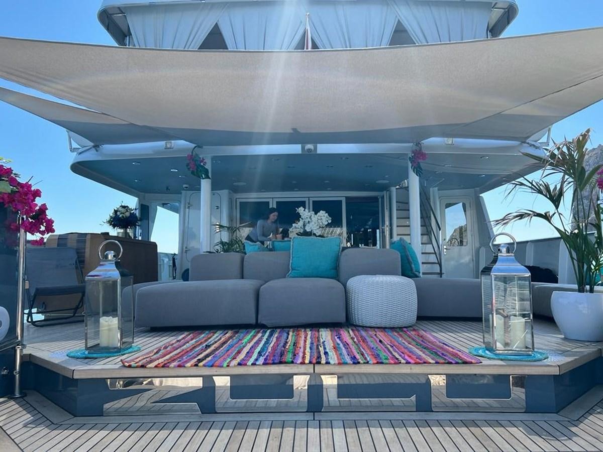 a large living room with a large balcony aboard ZULU Yacht for Sale