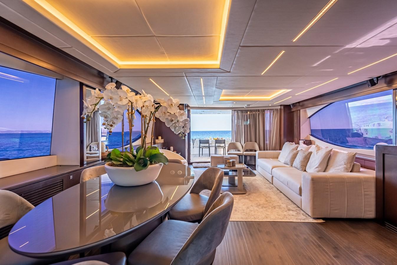 a living room with a large table and a large window aboard MOZZ II Yacht for Sale