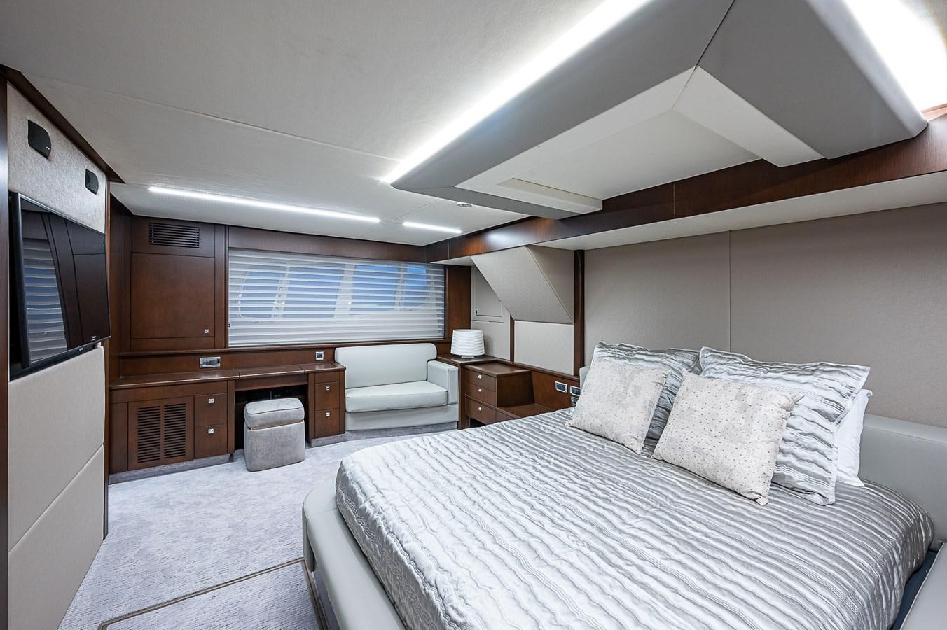 a bedroom with a bed and a desk aboard MOZZ II Yacht for Sale