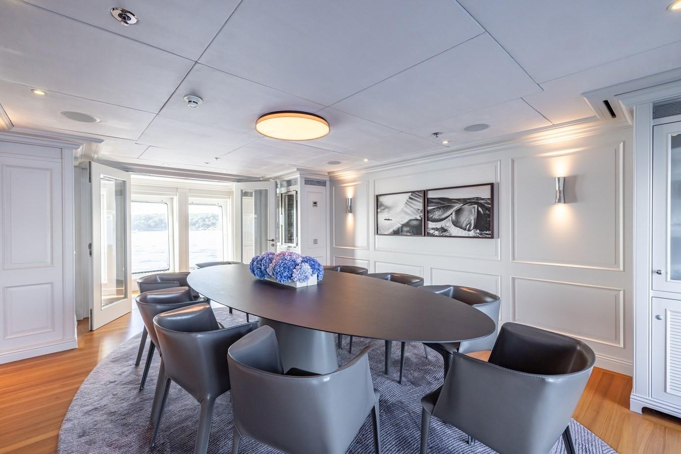 a large dining room with a table and chairs aboard BRAVADO Yacht for Sale