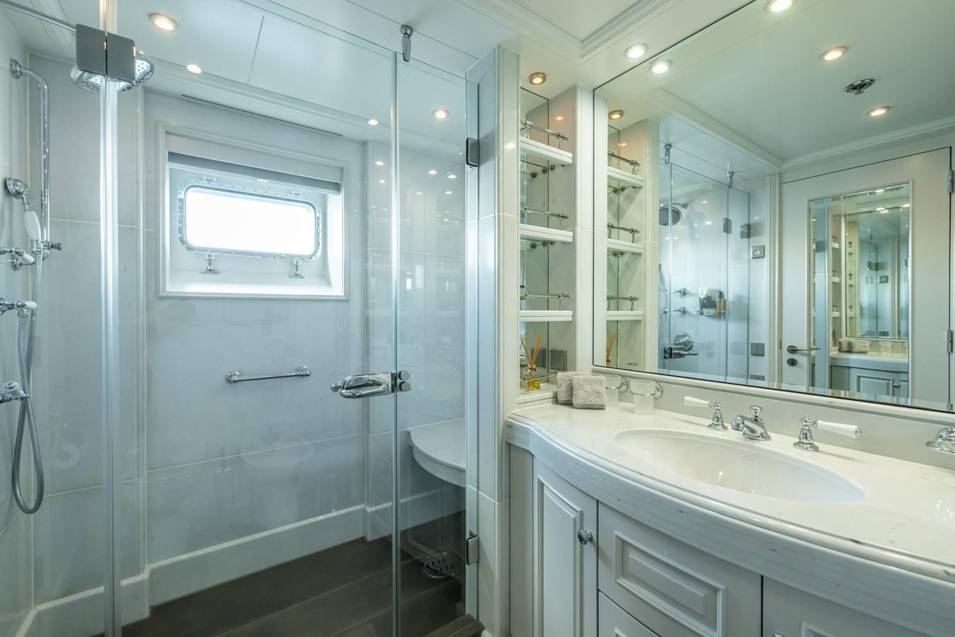 a bathroom with a shower and sink aboard BRAVADO Yacht for Sale