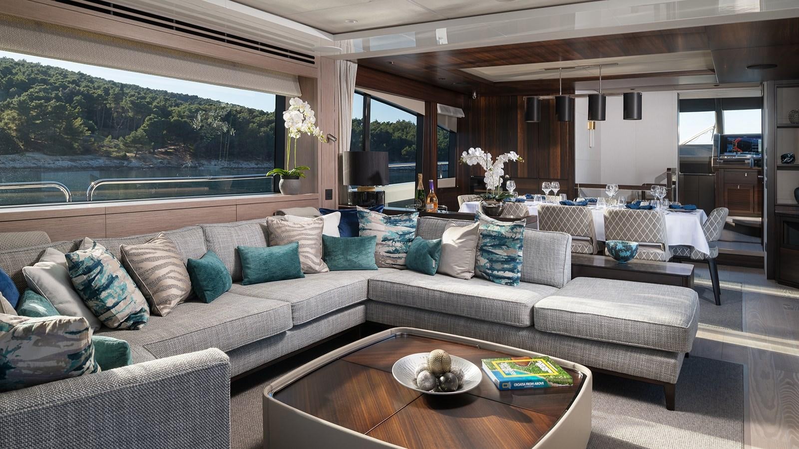 a living room with a couch and a table aboard MOWANA Yacht for Sale
