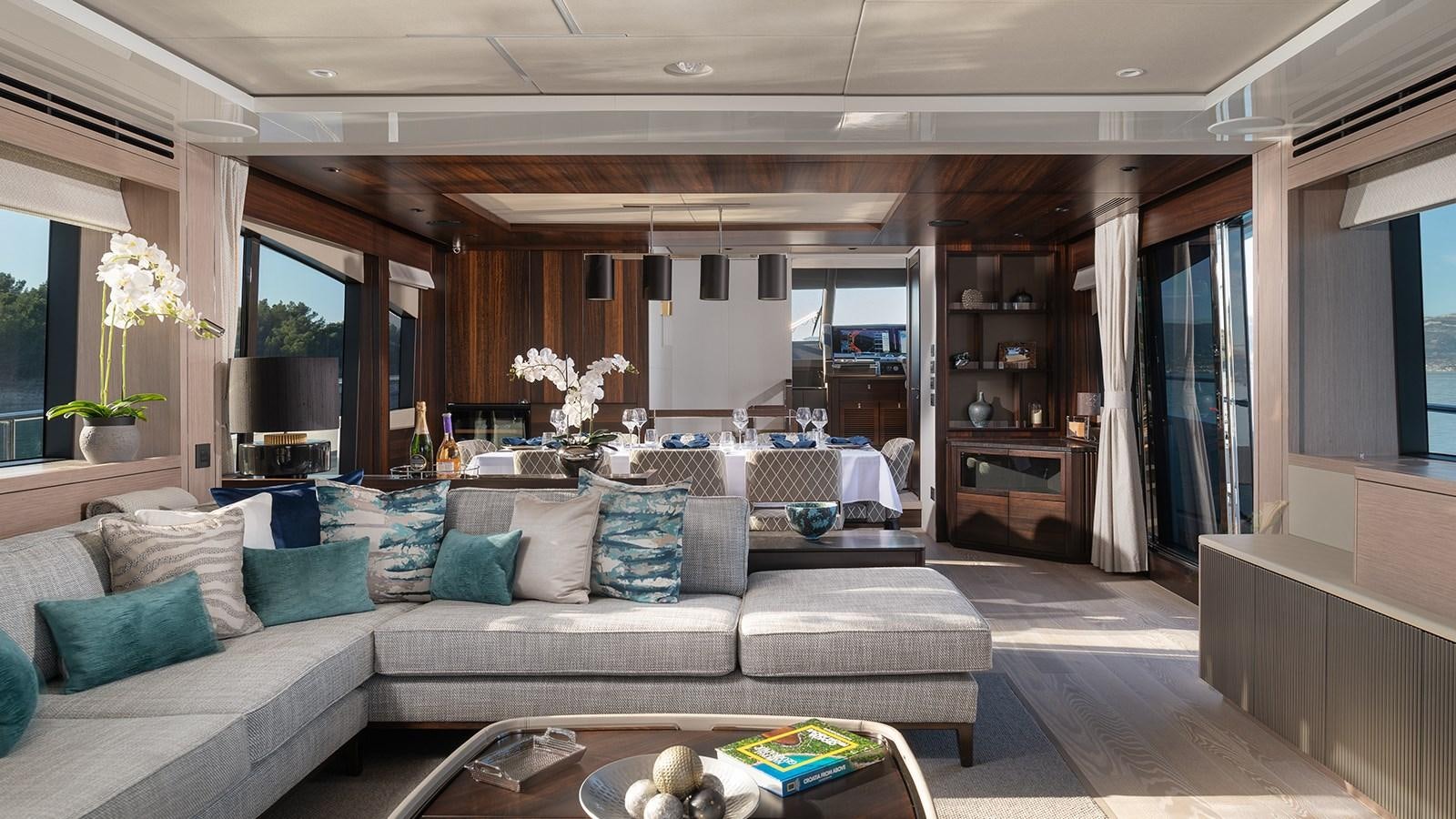 a living room with a couch and a table aboard MOWANA Yacht for Sale