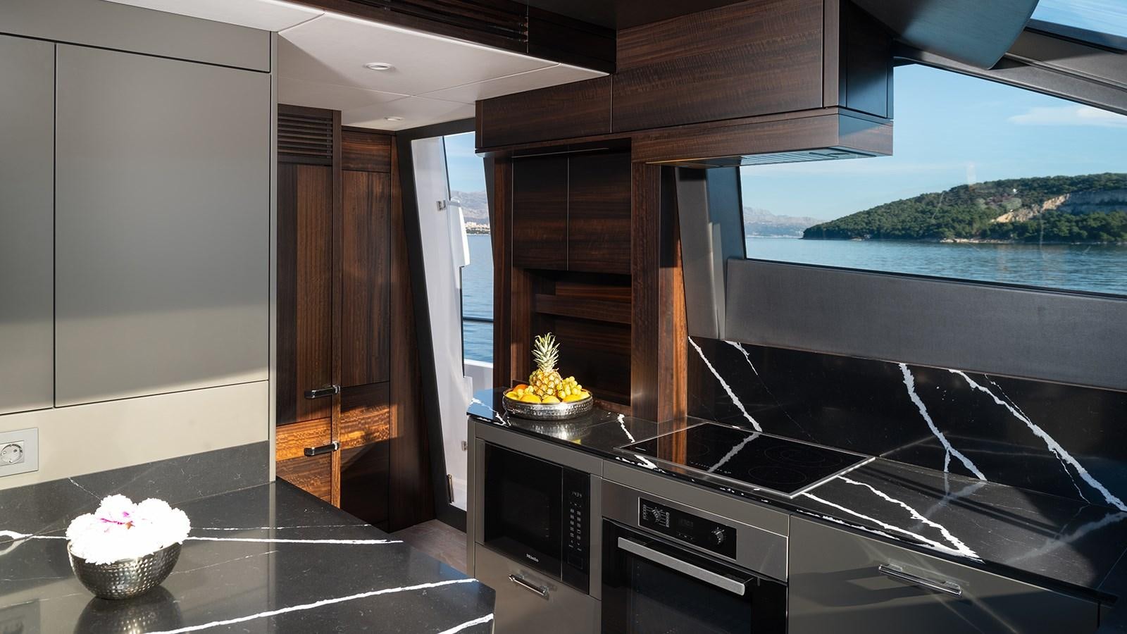 a kitchen with a large window aboard MOWANA Yacht for Sale