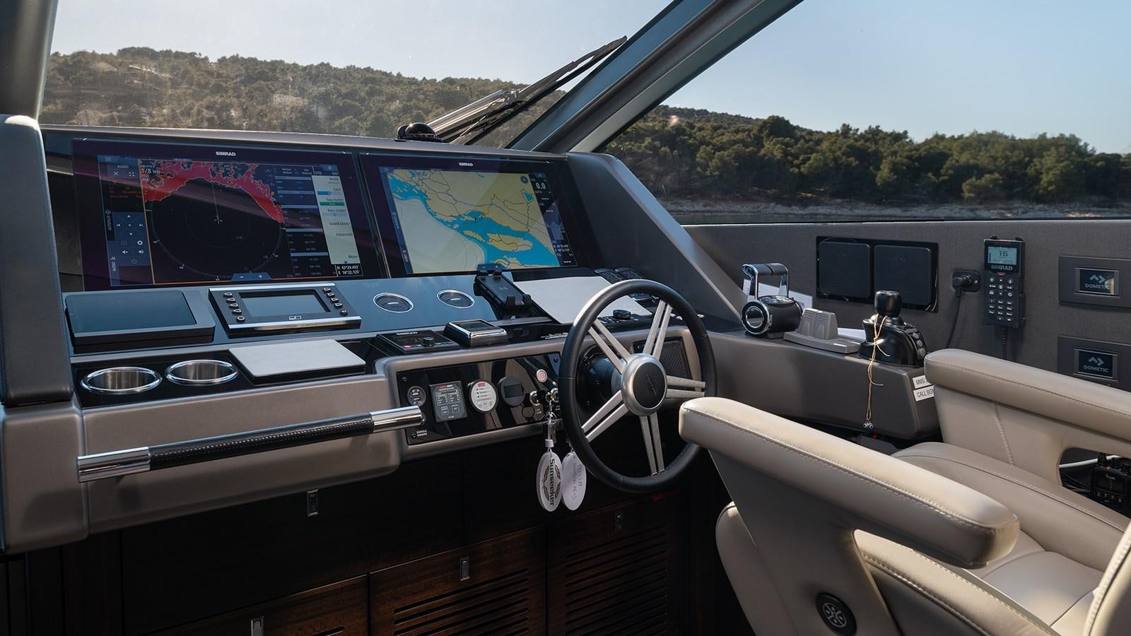 a car with a screen and a steering wheel on the side aboard MOWANA Yacht for Sale