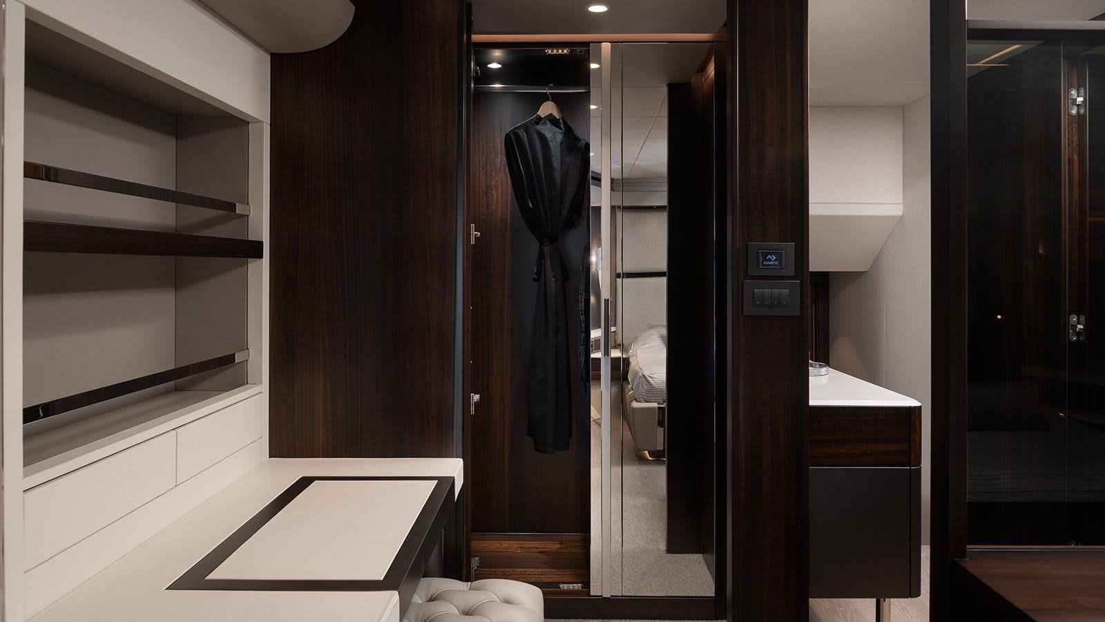a room with a black door and a black coat on the wall aboard MOWANA Yacht for Sale