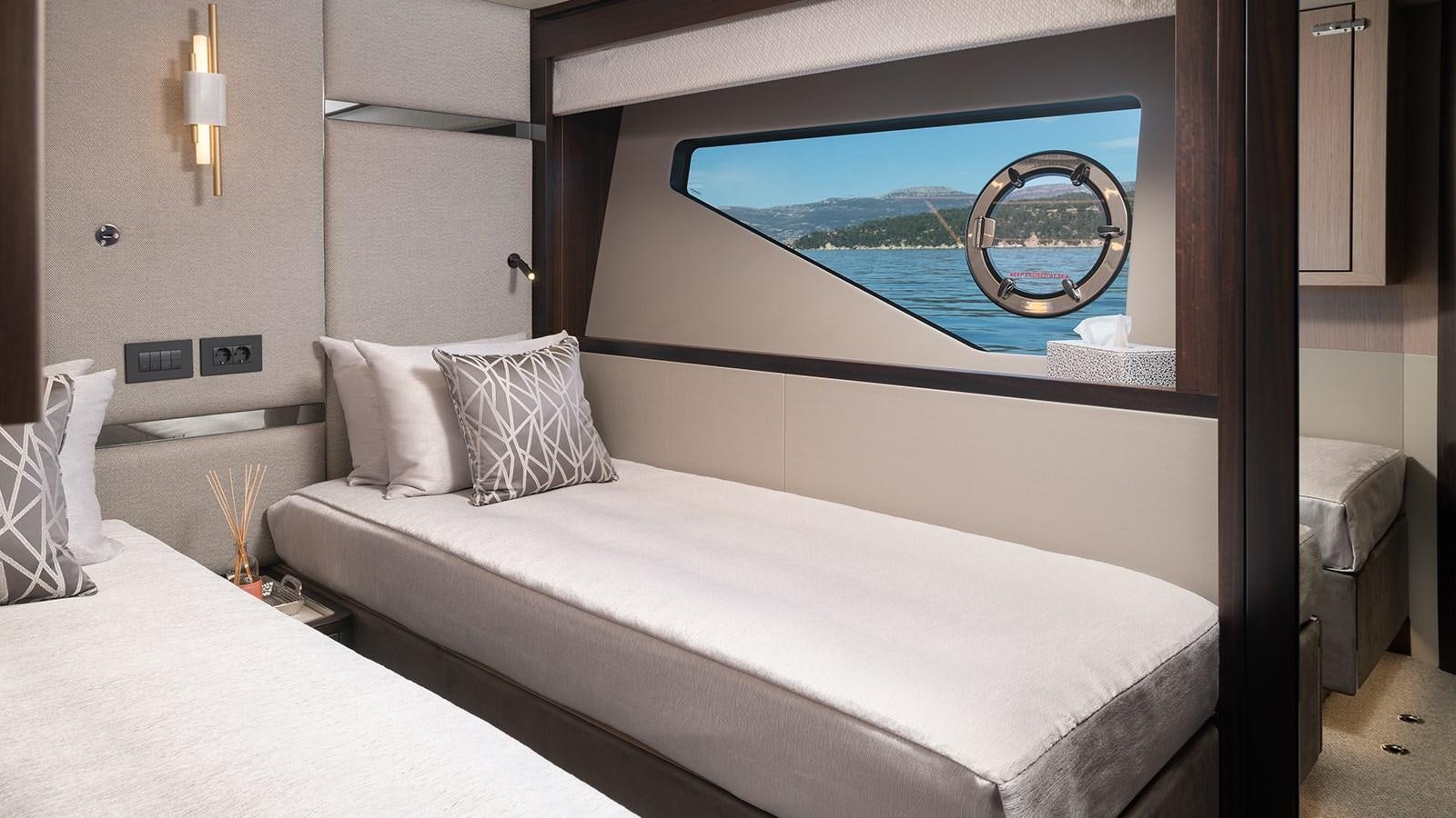 a bed with a picture on the wall aboard MOWANA Yacht for Sale