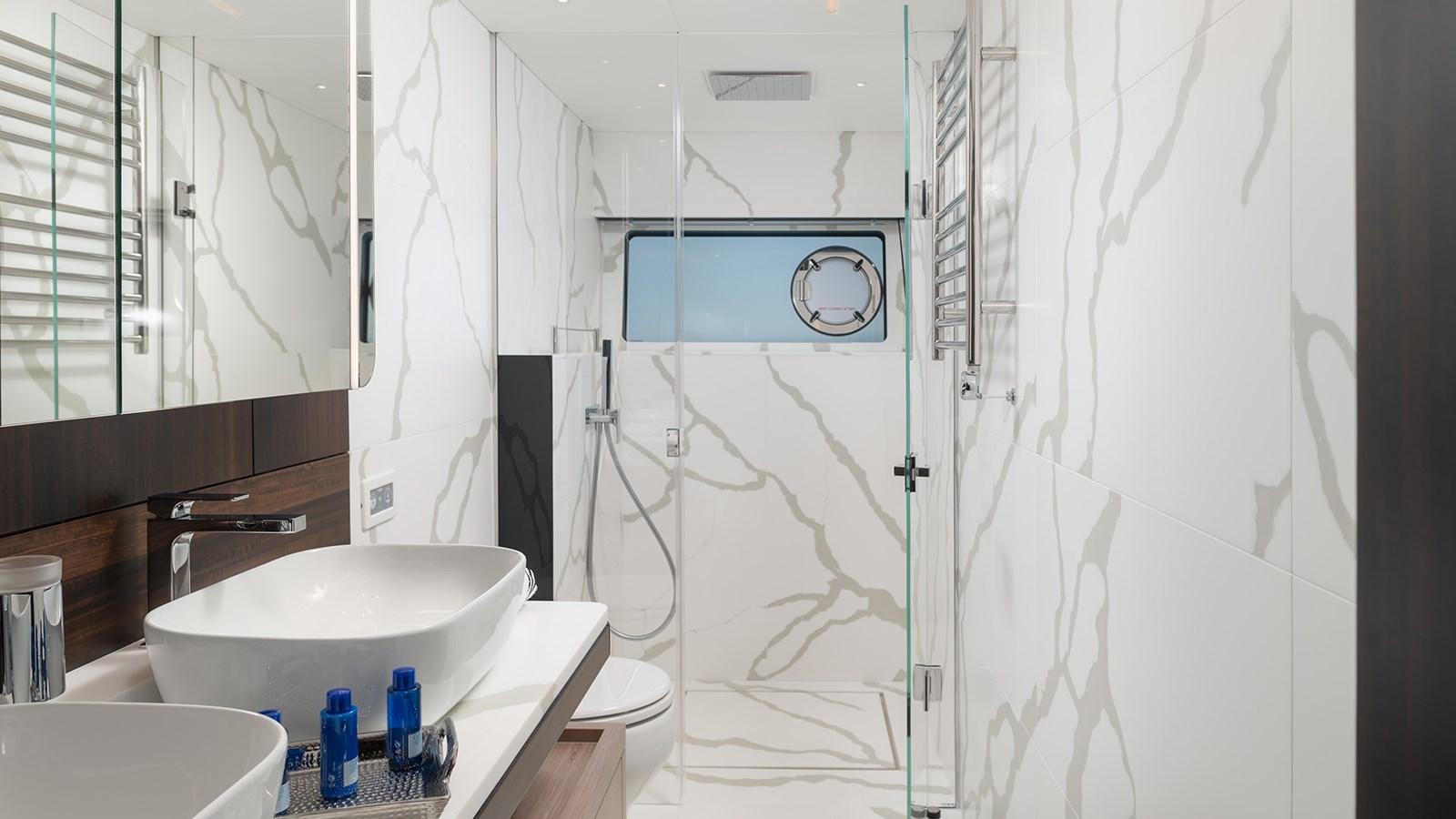 a bathroom with a sink and a shower aboard MOWANA Yacht for Sale