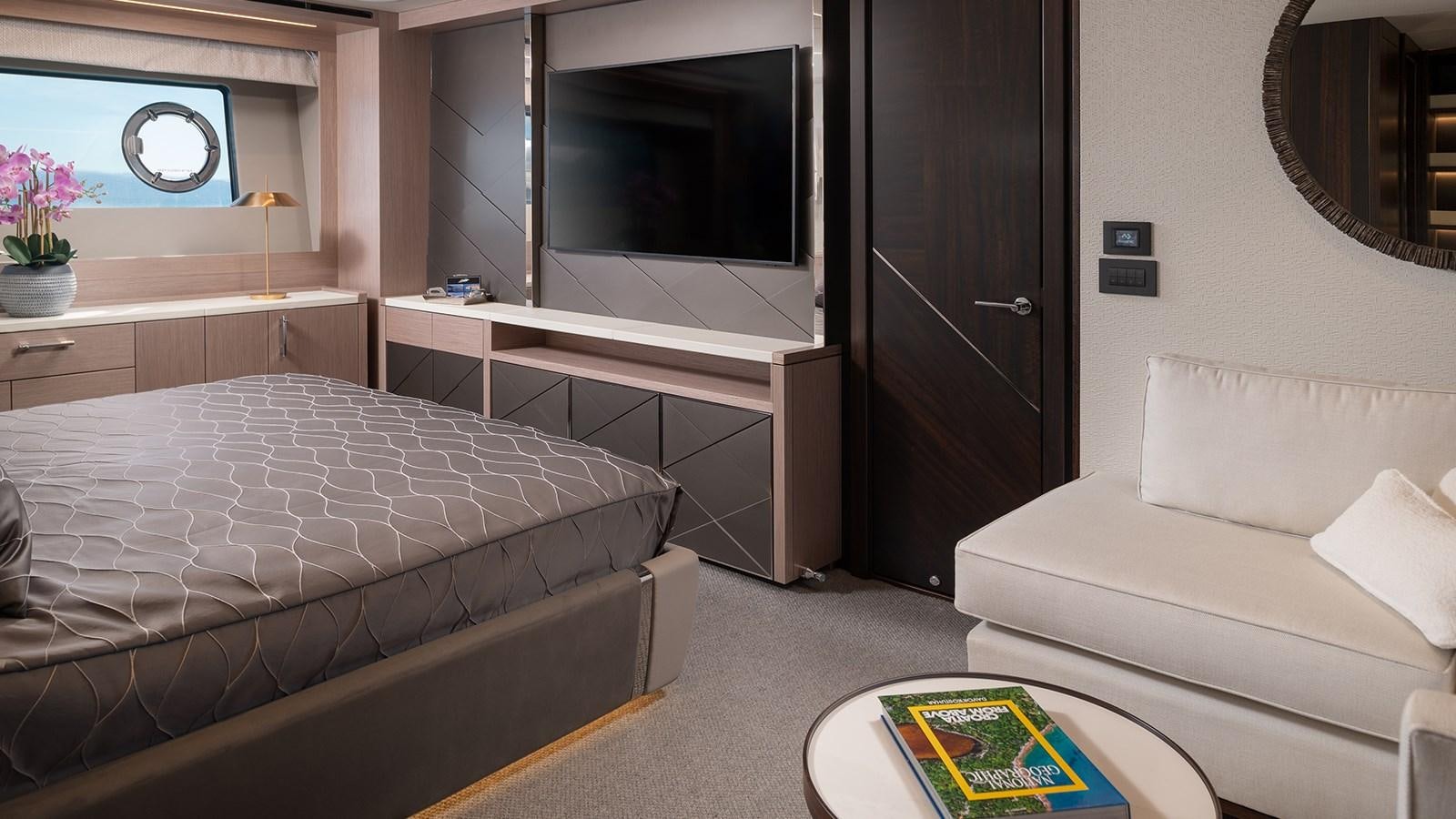 a room with a bed and a tv aboard MOWANA Yacht for Sale