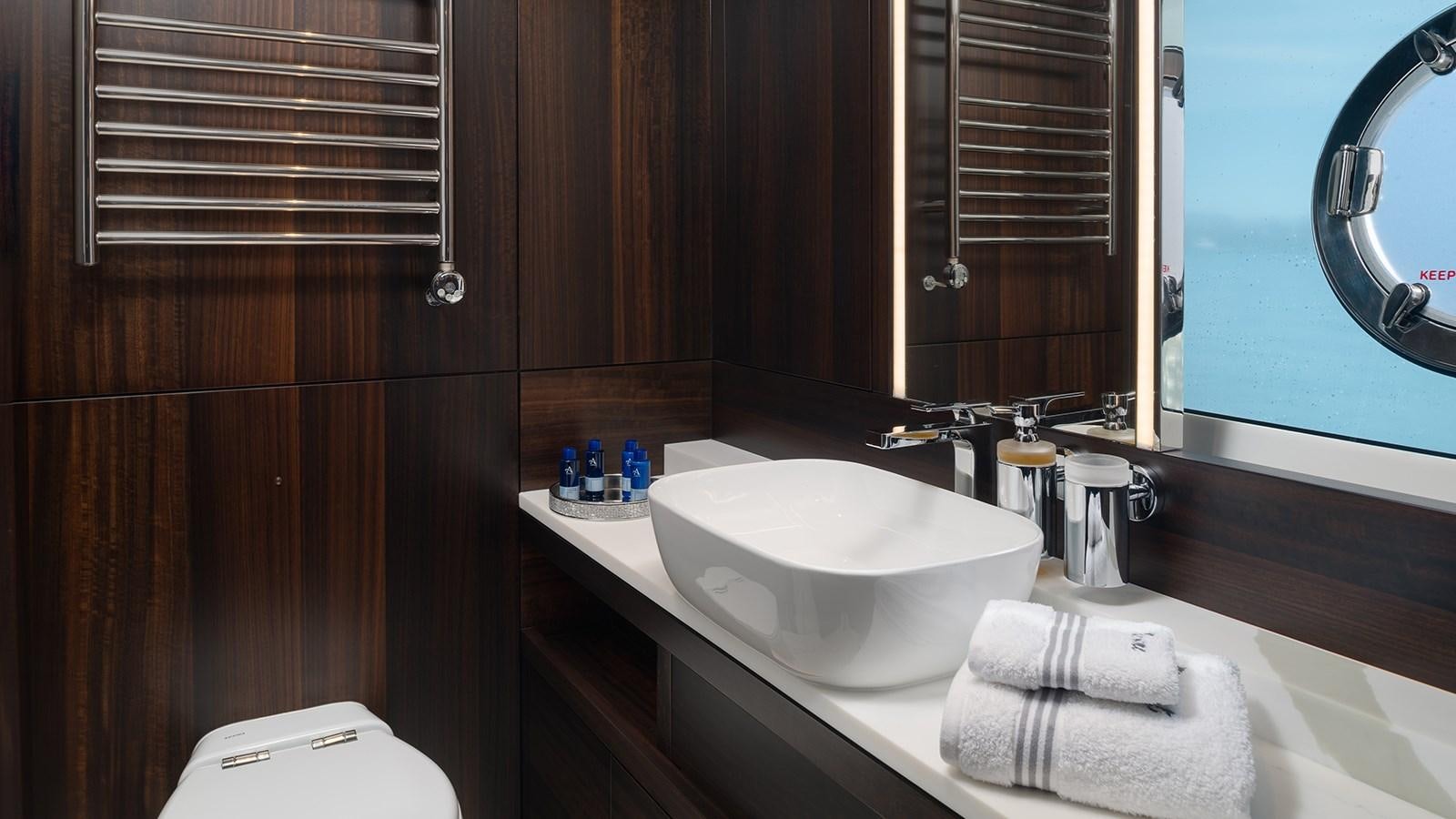 a bathroom with a sink and a mirror aboard MOWANA Yacht for Sale