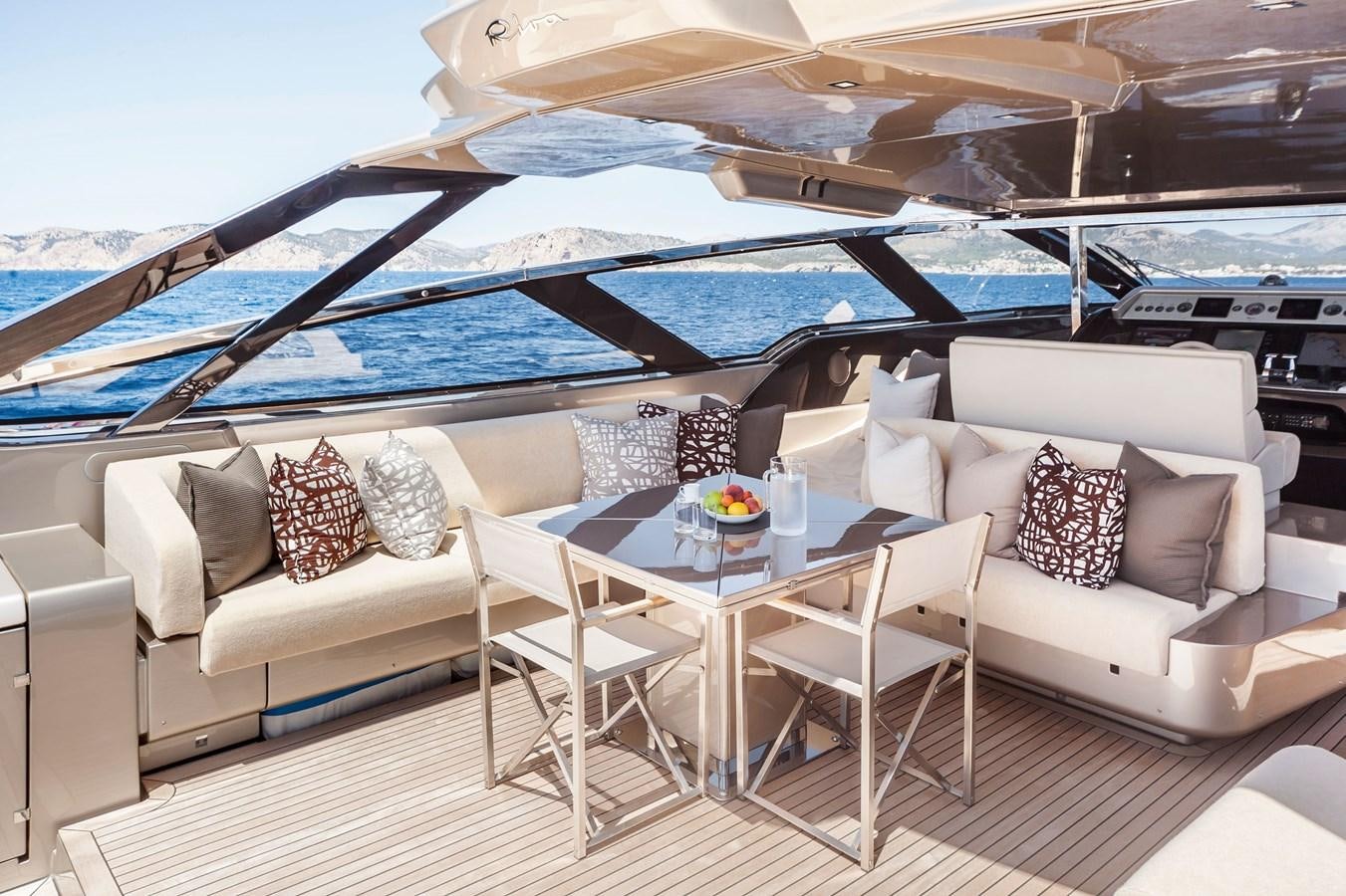 a white couch and a table on a boat aboard MINE Yacht for Sale