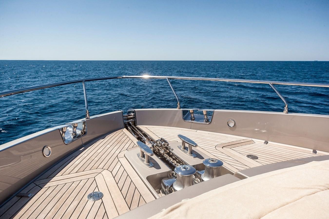 a deck with a view of the ocean and the sun aboard MINE Yacht for Sale