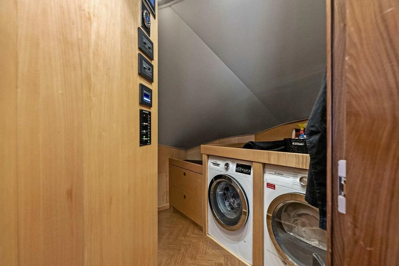 a laundry room with a washing machine aboard TEAM MAYHEM Yacht for Sale