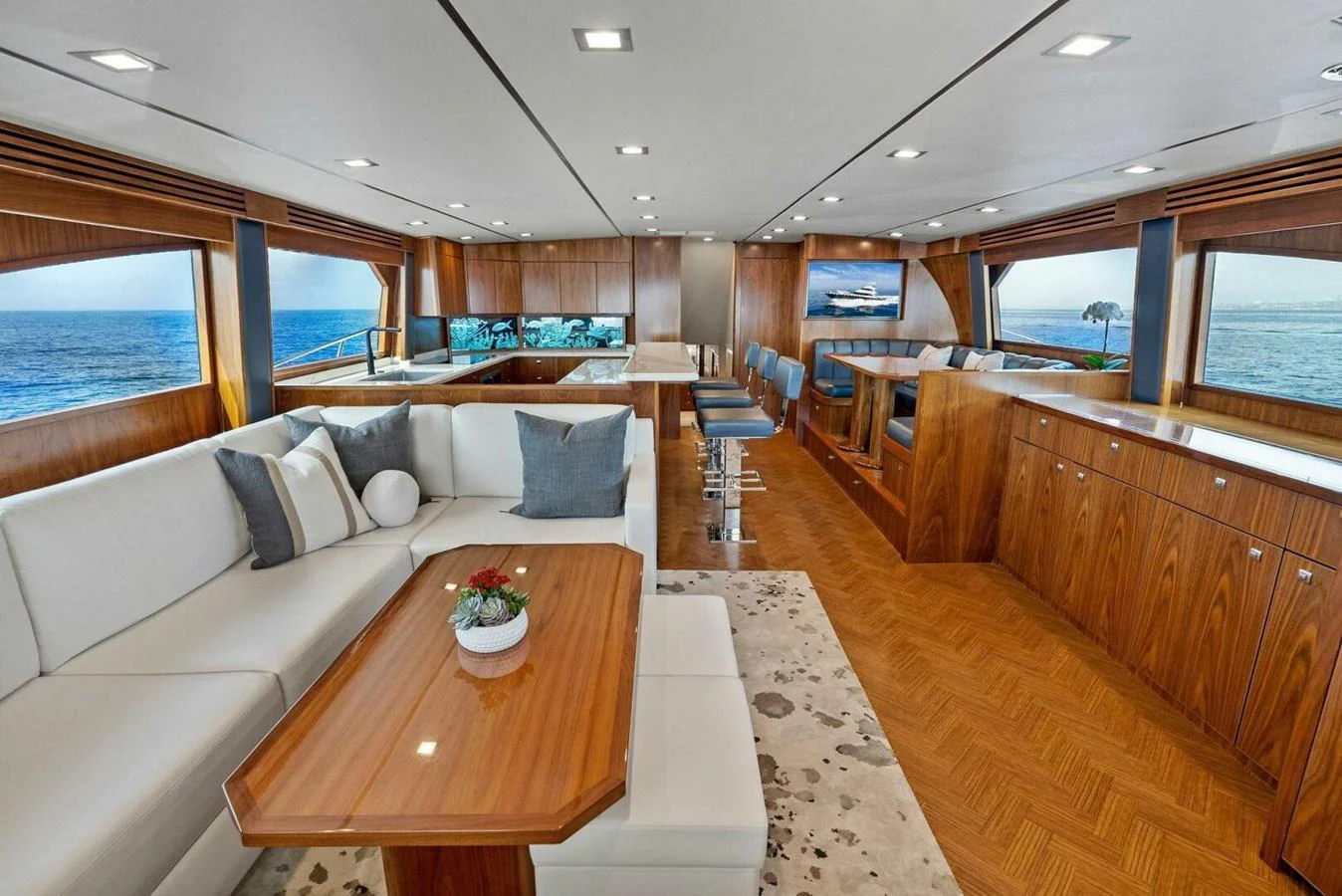 a room with a couch and a table and chairs aboard TEAM MAYHEM Yacht for Sale