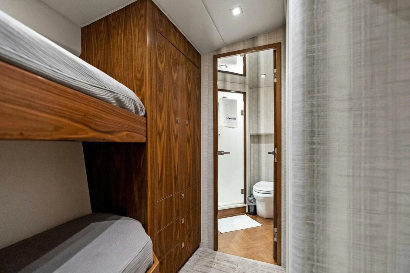 a room with a bed and a closet aboard TEAM MAYHEM Yacht for Sale