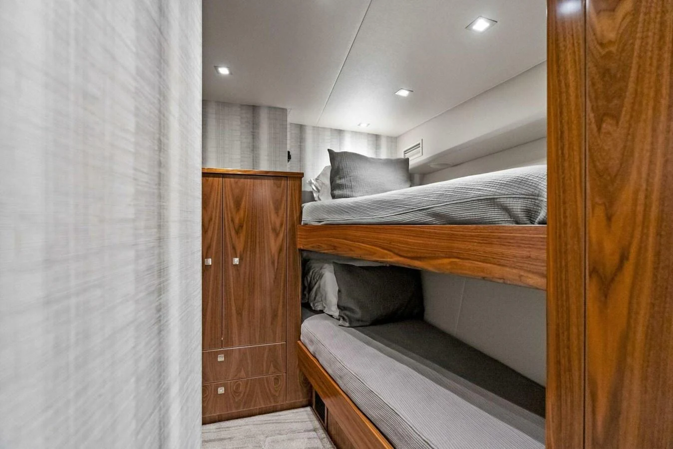 a room with a bed and a closet aboard TEAM MAYHEM Yacht for Sale