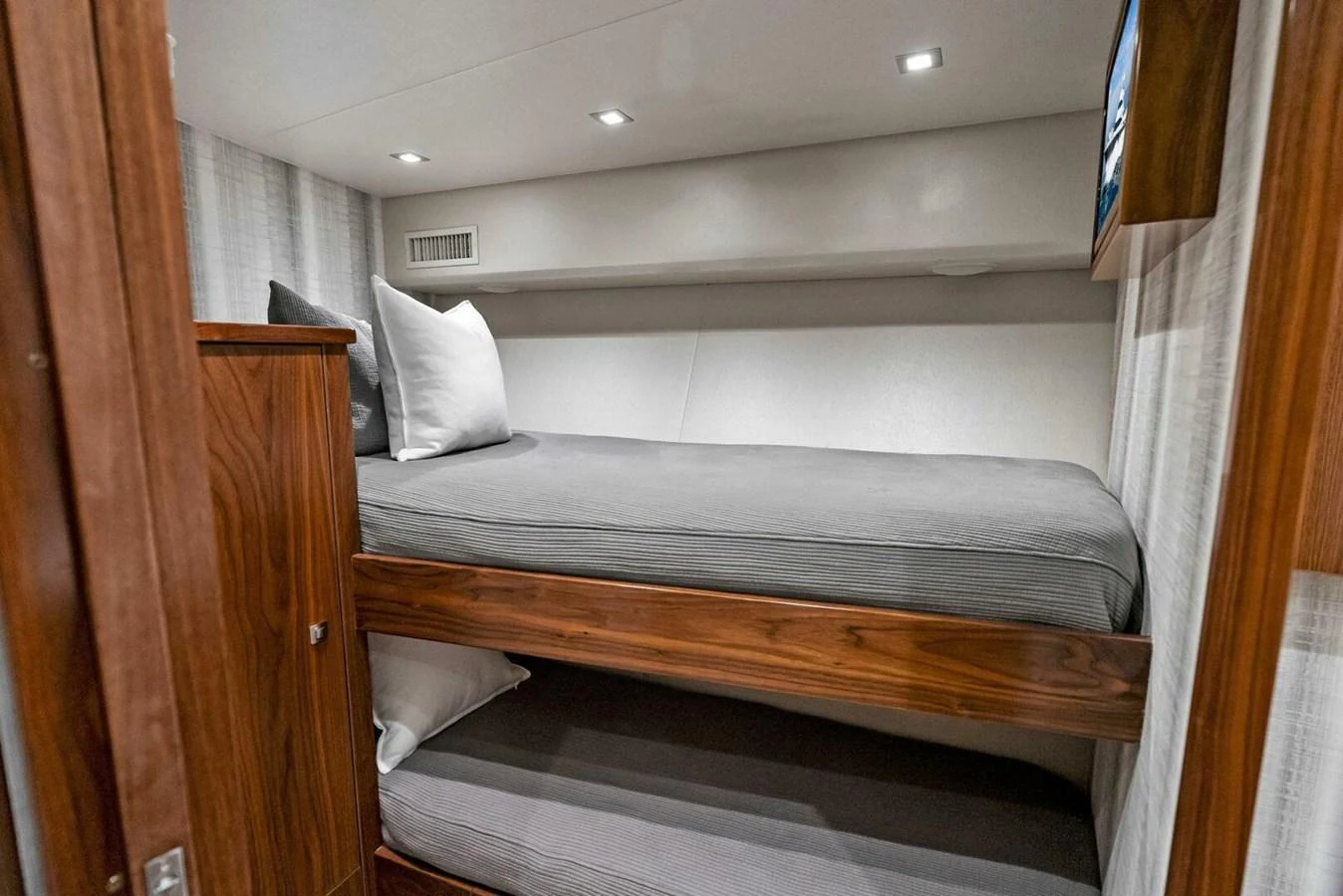 a bed with a wooden frame aboard TEAM MAYHEM Yacht for Sale
