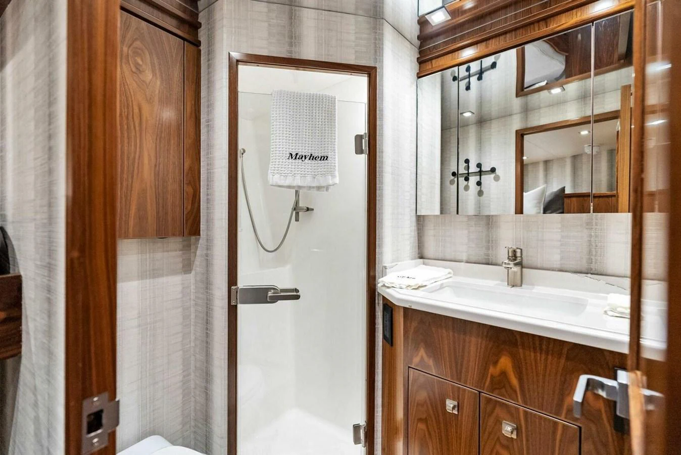 a bathroom with a mirror and a sink aboard TEAM MAYHEM Yacht for Sale