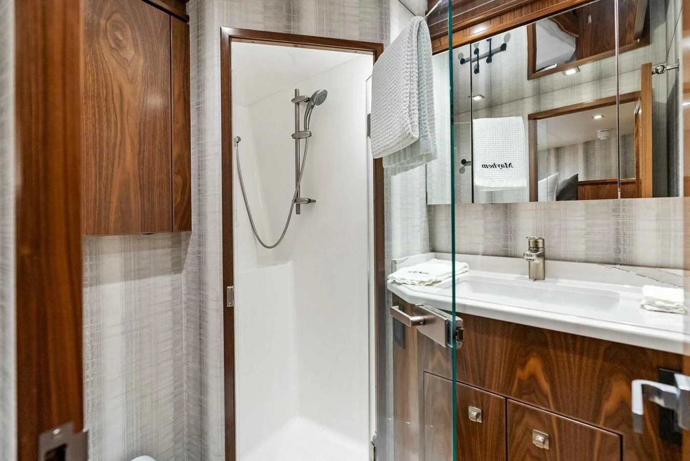 a bathroom with a mirror and a sink aboard TEAM MAYHEM Yacht for Sale