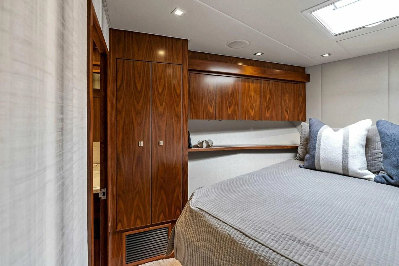 a room with a bed and a closet aboard TEAM MAYHEM Yacht for Sale