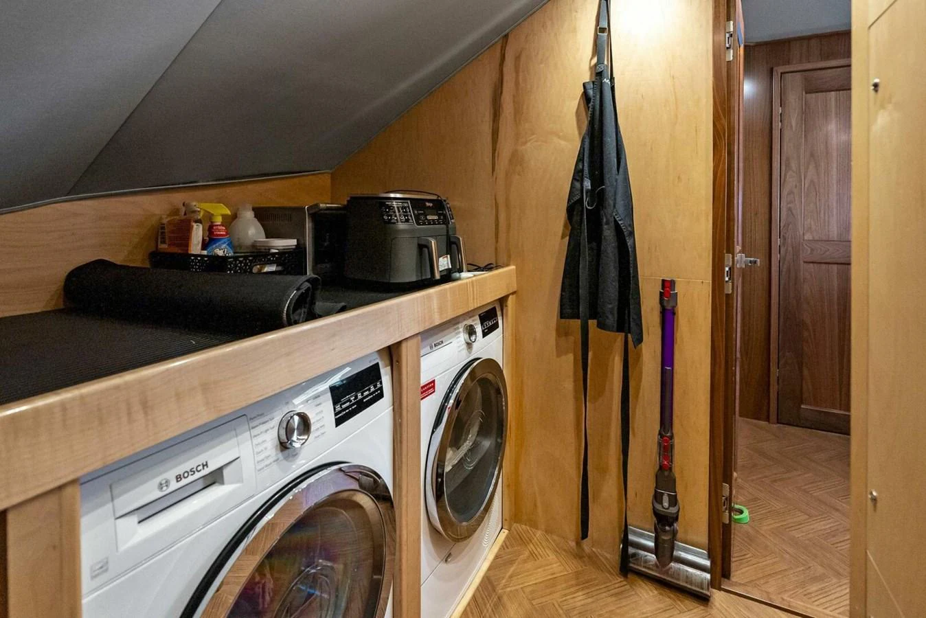a kitchen with a washing machine and a dryer aboard TEAM MAYHEM Yacht for Sale