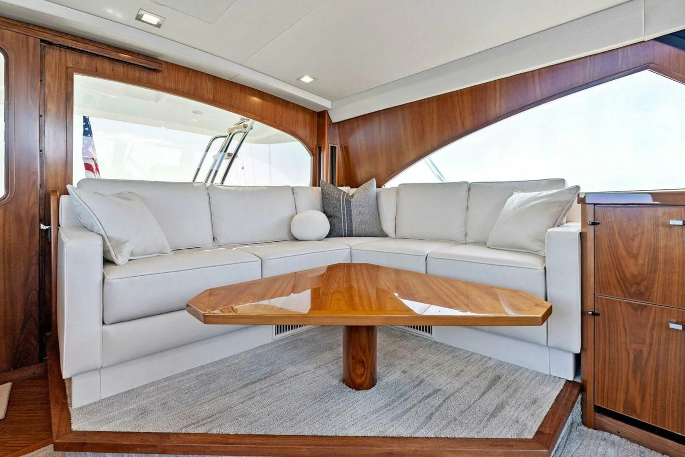 a living room with a couch and a table aboard TEAM MAYHEM Yacht for Sale