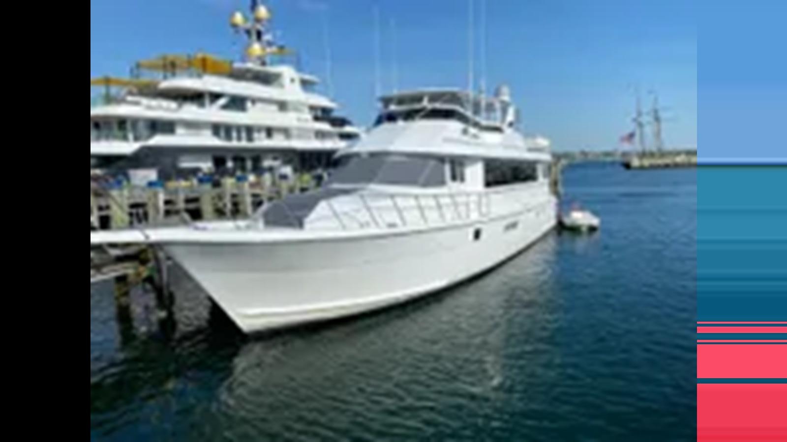 a large white boat in the water aboard 1999 HATTERAS 74 SPORT DECK MOTOR YACHT Yacht for Sale
