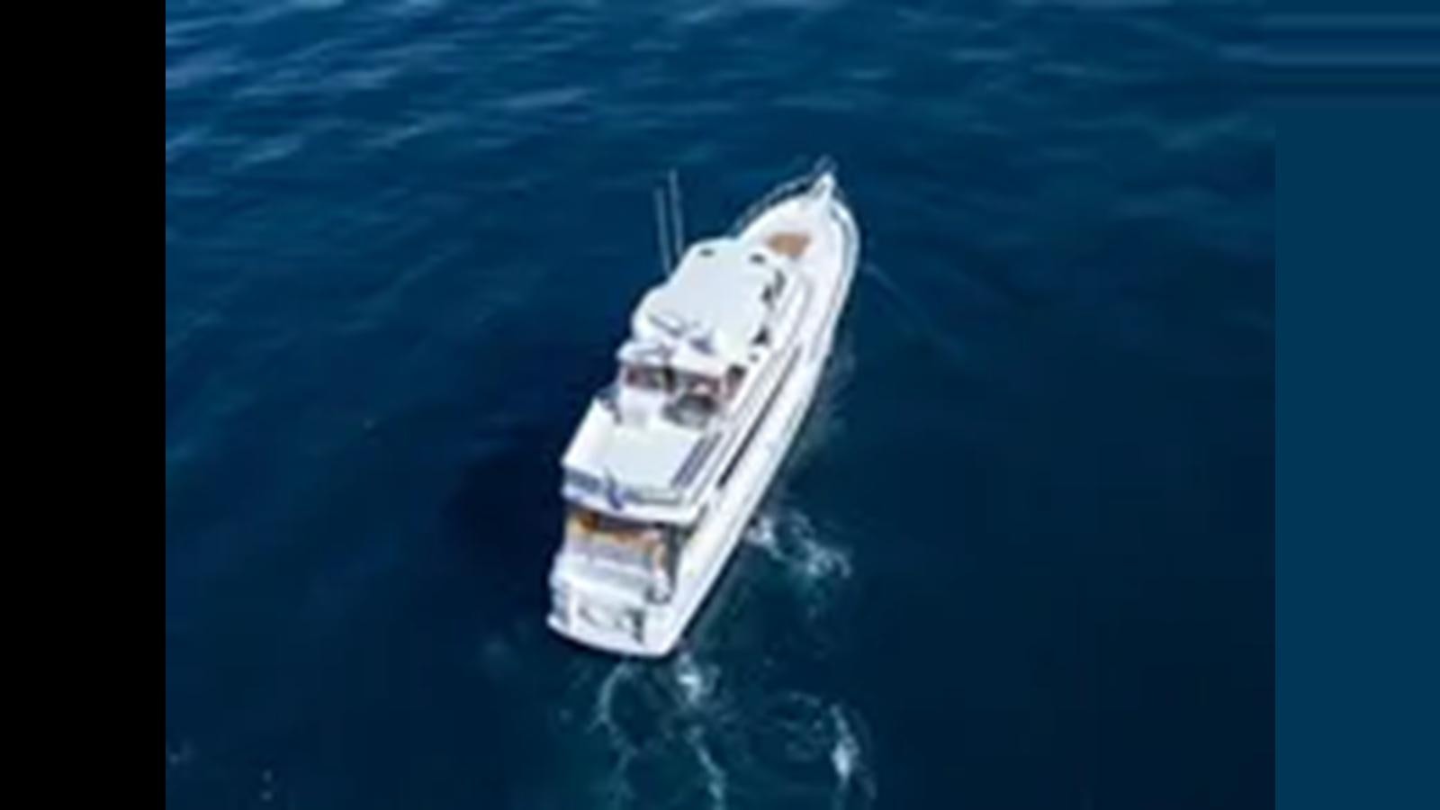 a ship in the water aboard 1999 HATTERAS 74 SPORT DECK MOTOR YACHT Yacht for Sale