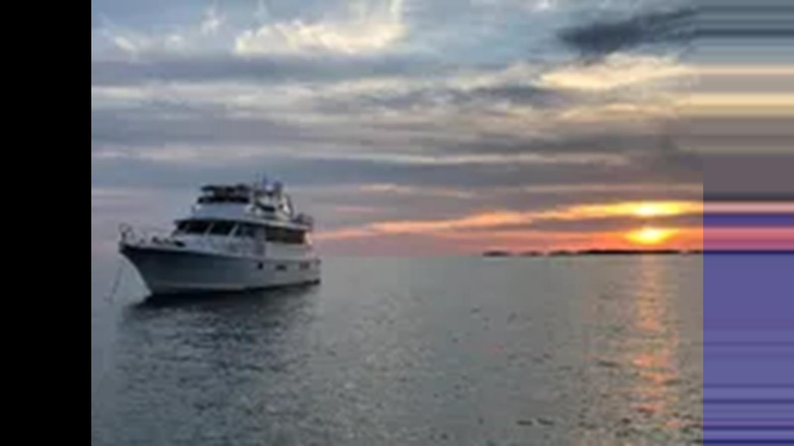 a boat on the water aboard 1999 HATTERAS 74 SPORT DECK MOTOR YACHT Yacht for Sale