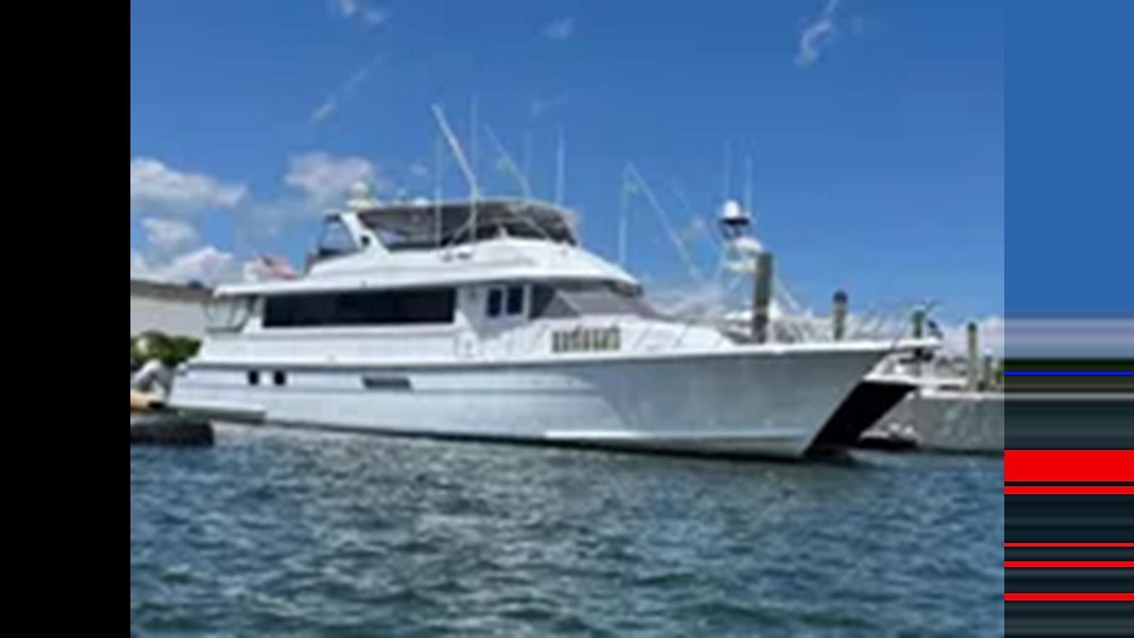 a large white boat aboard 1999 HATTERAS 74 SPORT DECK MOTOR YACHT Yacht for Sale