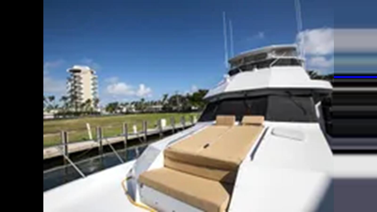 a boat on a deck aboard 1999 HATTERAS 74 SPORT DECK MOTOR YACHT Yacht for Sale