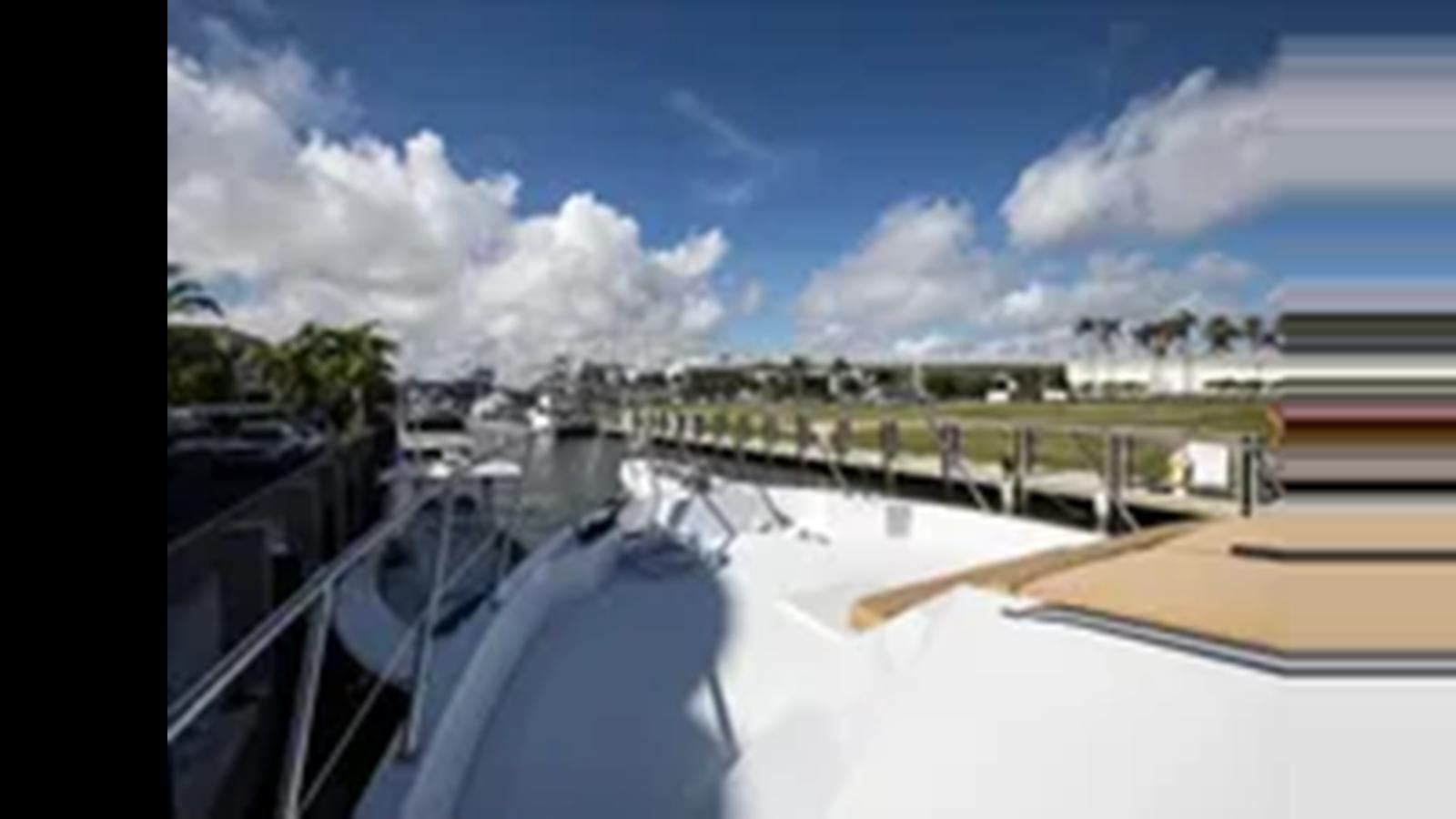 a bridge over water aboard 1999 HATTERAS 74 SPORT DECK MOTOR YACHT Yacht for Sale