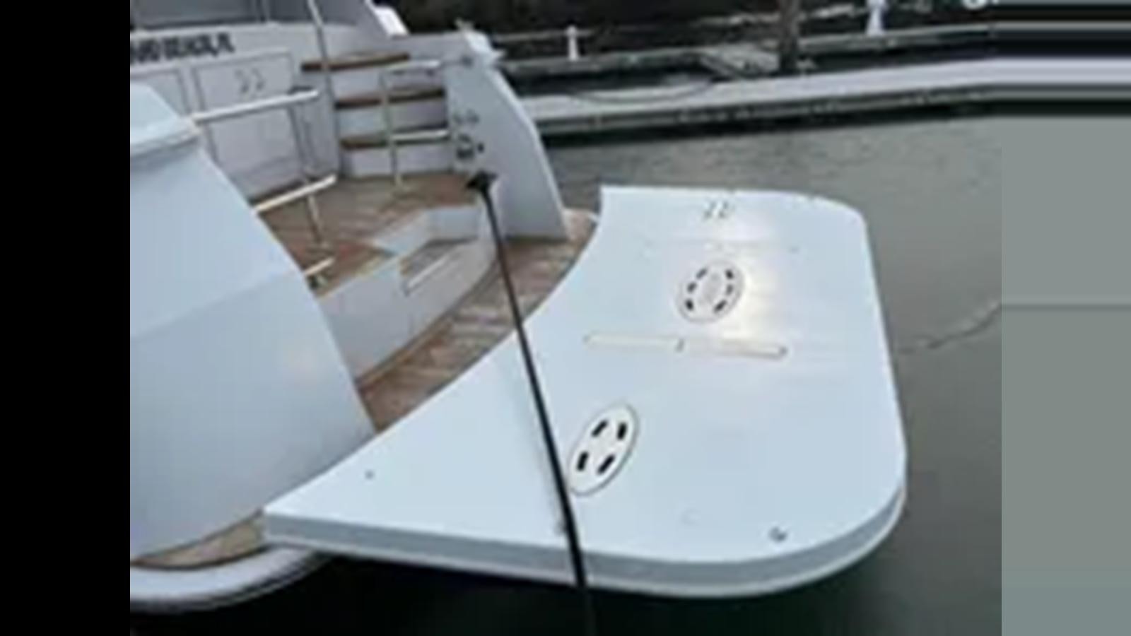 a white rectangular object with a black circle on it aboard 1999 HATTERAS 74 SPORT DECK MOTOR YACHT Yacht for Sale