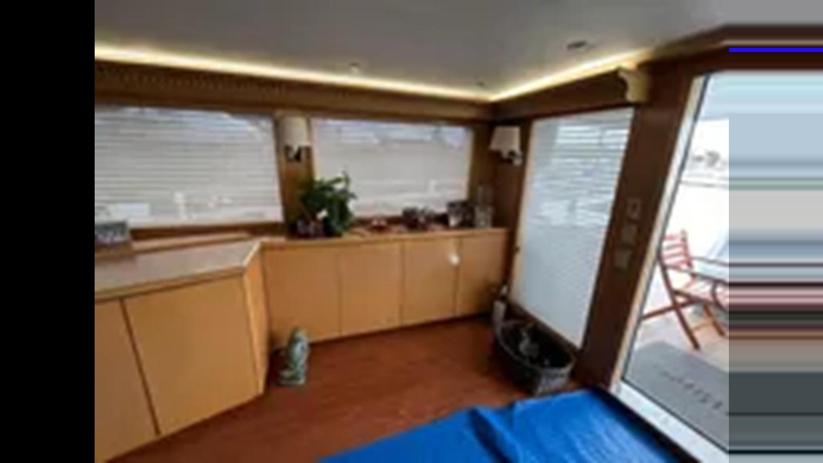 a room with a window and a desk aboard 1999 HATTERAS 74 SPORT DECK MOTOR YACHT Yacht for Sale