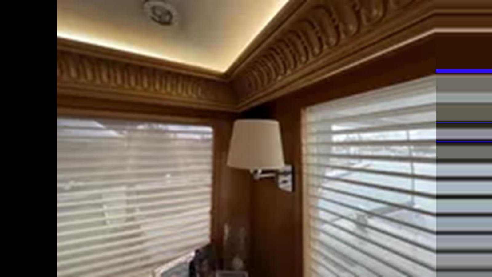 a room with a lamp and a window aboard 1999 HATTERAS 74 SPORT DECK MOTOR YACHT Yacht for Sale