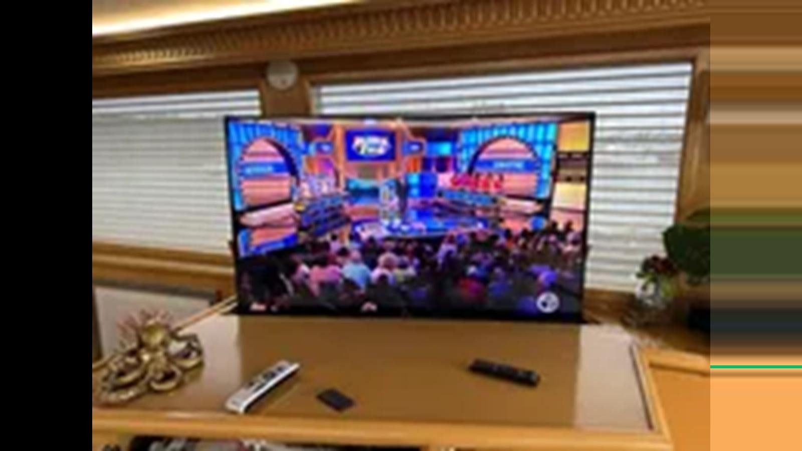 a tv on a table aboard 1999 HATTERAS 74 SPORT DECK MOTOR YACHT Yacht for Sale