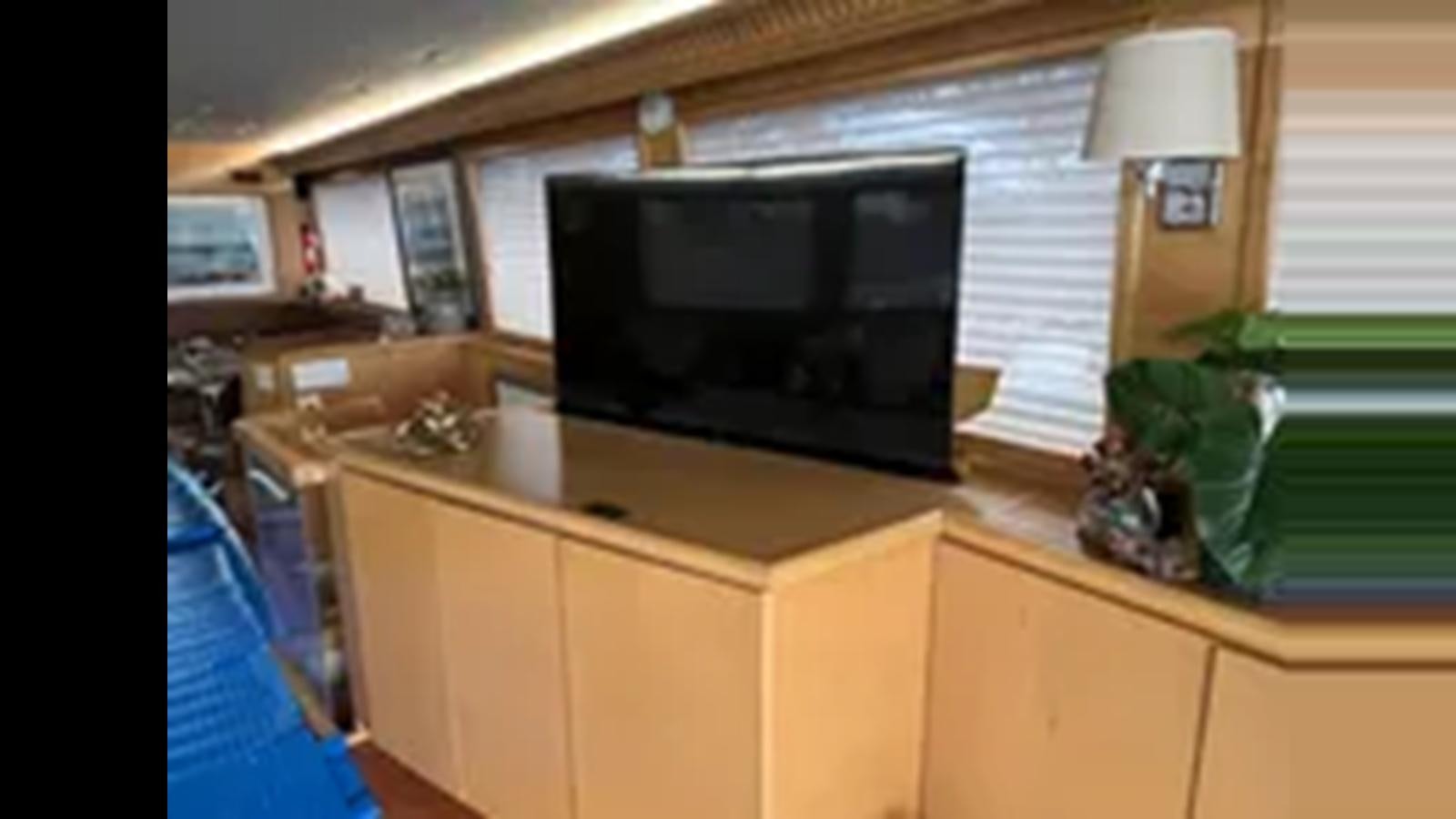 a tv on a counter aboard 1999 HATTERAS 74 SPORT DECK MOTOR YACHT Yacht for Sale