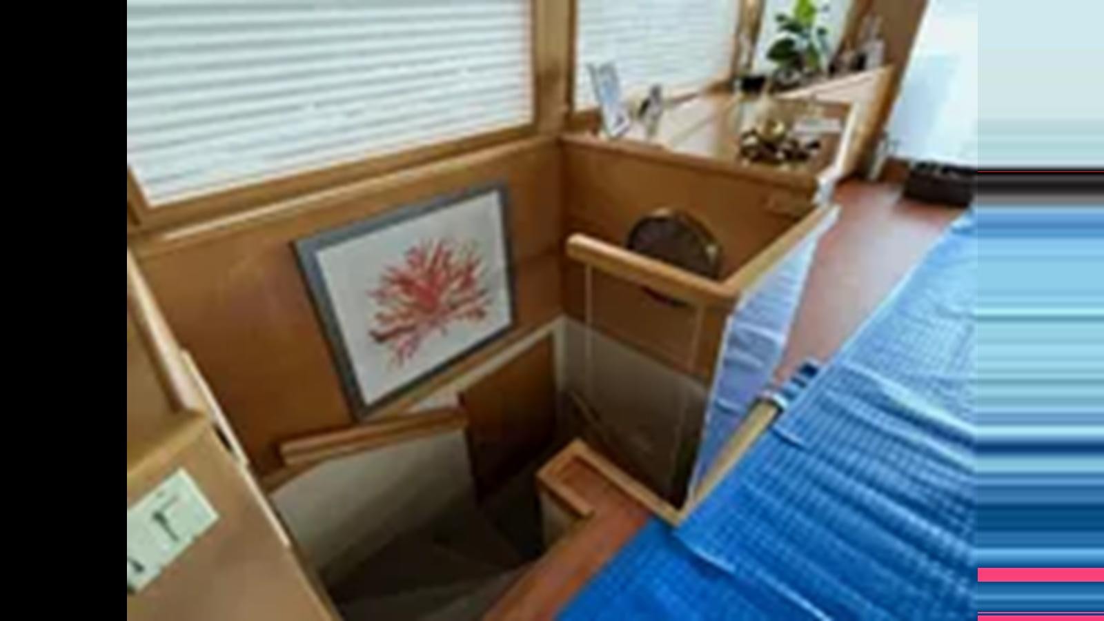 a person holding a towel aboard 1999 HATTERAS 74 SPORT DECK MOTOR YACHT Yacht for Sale