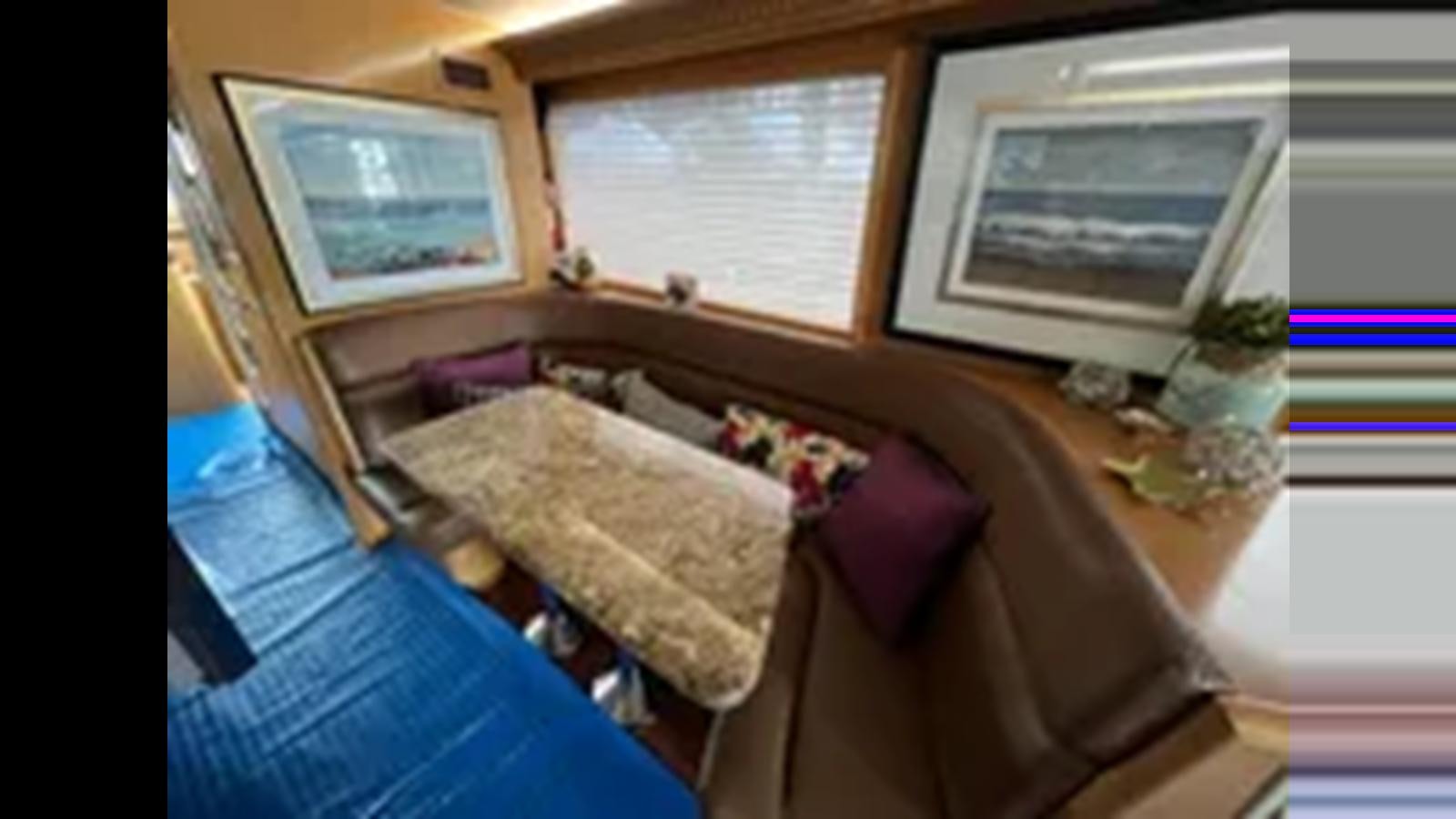 a bed with a pillow on it aboard 1999 HATTERAS 74 SPORT DECK MOTOR YACHT Yacht for Sale