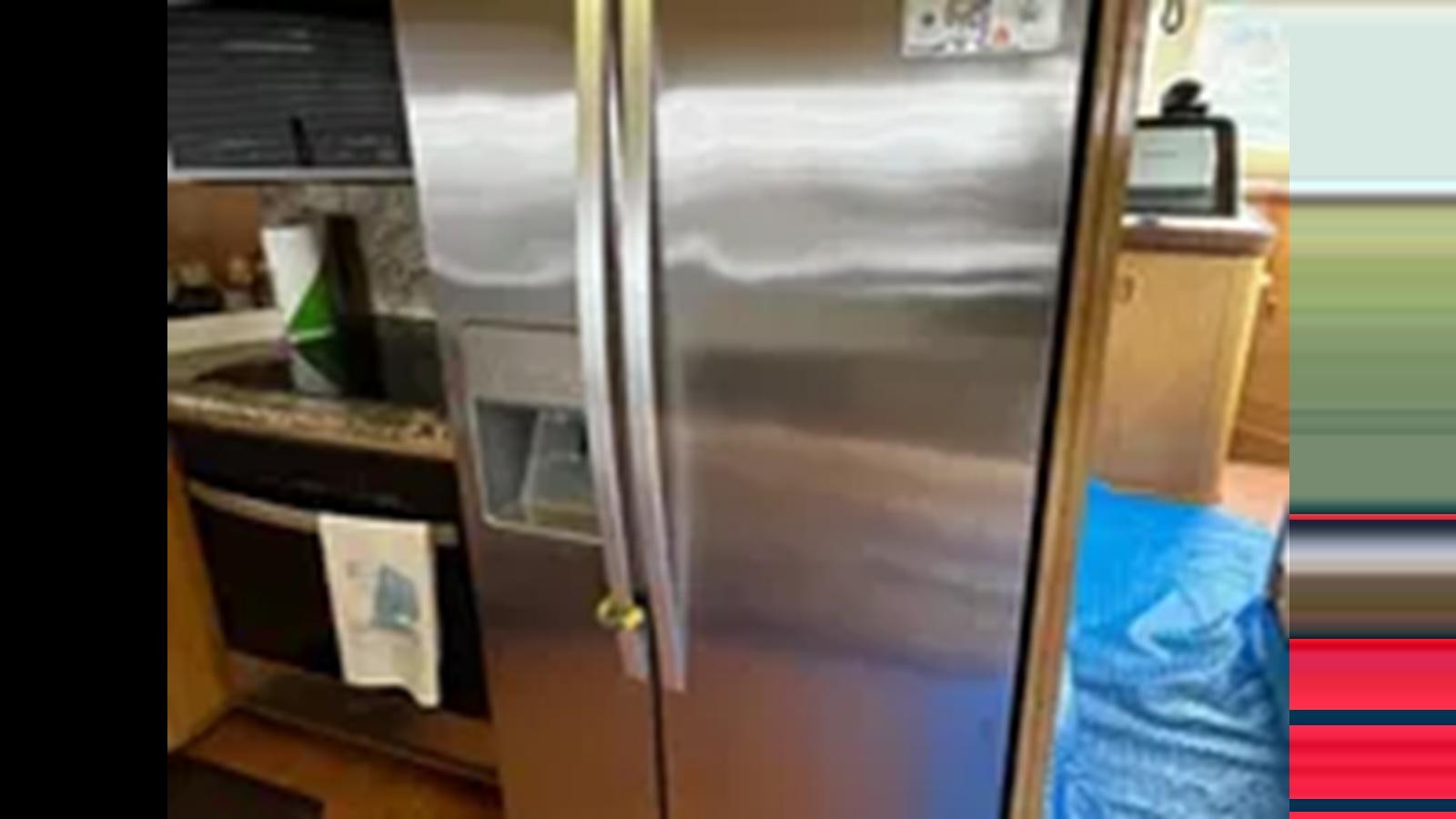 a large silver refrigerator aboard 1999 HATTERAS 74 SPORT DECK MOTOR YACHT Yacht for Sale
