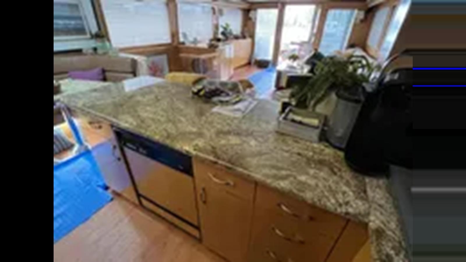 a room with a table and a chair aboard 1999 HATTERAS 74 SPORT DECK MOTOR YACHT Yacht for Sale