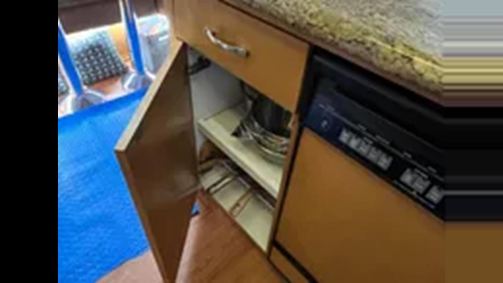 a kitchen with a sink and cabinets aboard 1999 HATTERAS 74 SPORT DECK MOTOR YACHT Yacht for Sale