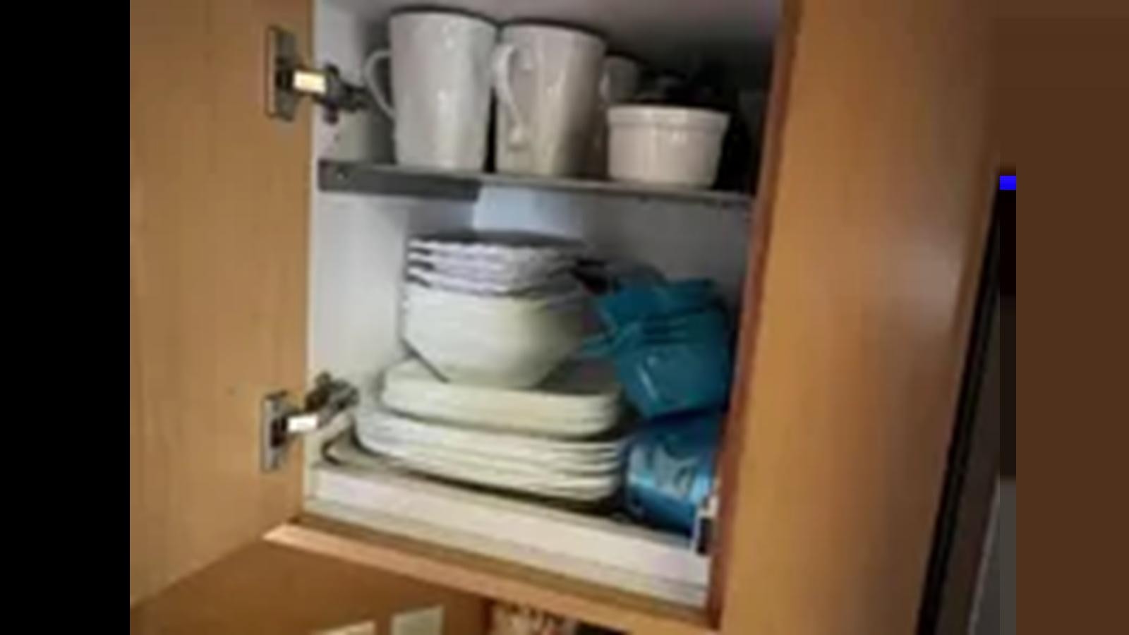 a white dishwasher with dishes on it aboard 1999 HATTERAS 74 SPORT DECK MOTOR YACHT Yacht for Sale