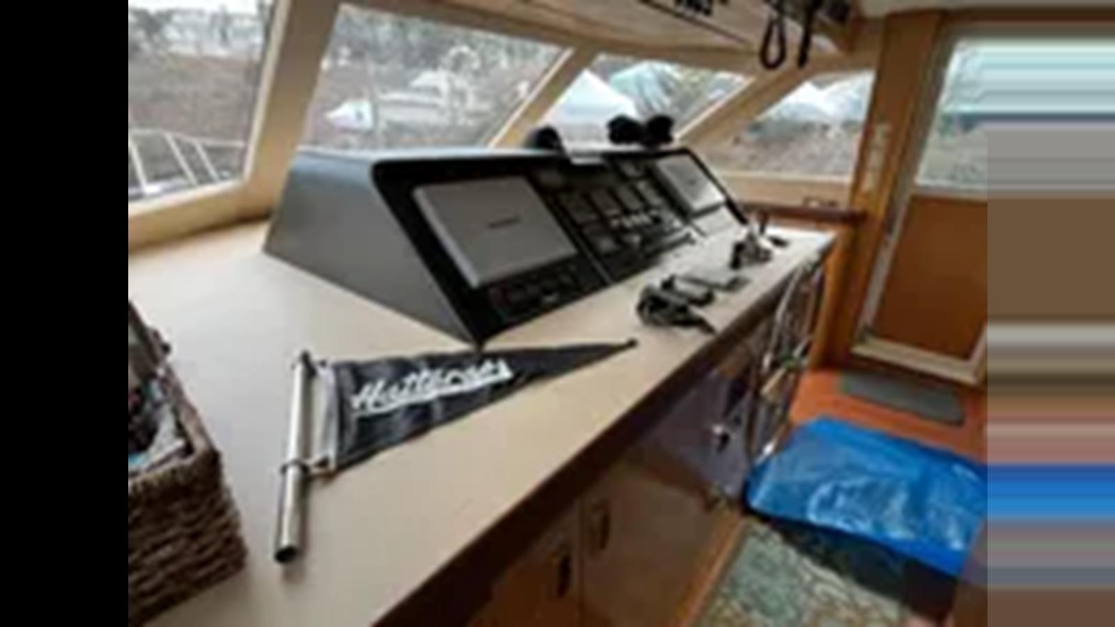 a kitchen with a stove and cabinets aboard 1999 HATTERAS 74 SPORT DECK MOTOR YACHT Yacht for Sale